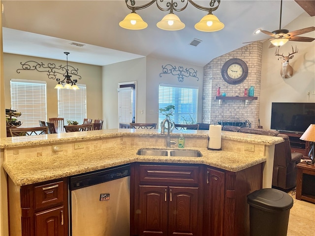 kitchen with ceiling fan with notable chandelier, sink, decorative light fixtures, dishwasher, and lofted ceiling