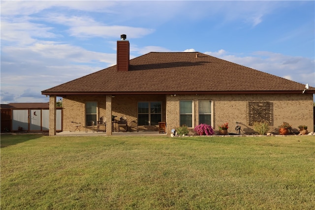 rear view of house featuring a lawn