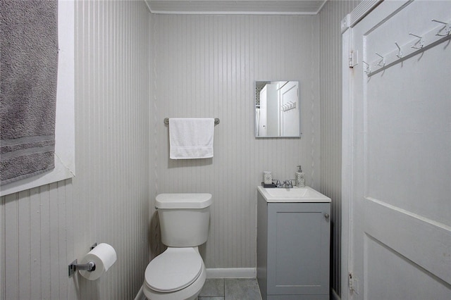 bathroom featuring toilet, vanity, and tile patterned flooring