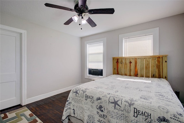 bedroom with dark wood-type flooring, cooling unit, and ceiling fan