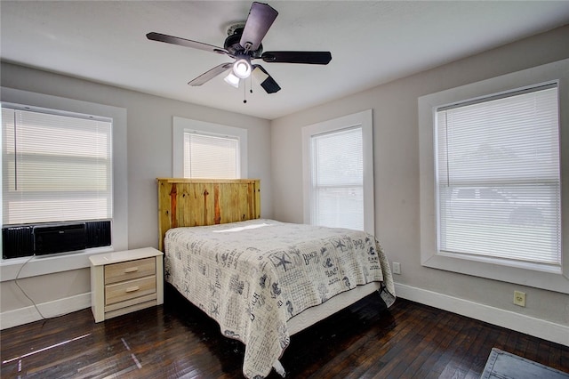 bedroom featuring ceiling fan, dark hardwood / wood-style floors, and cooling unit