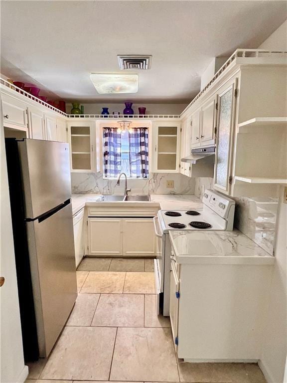 4505 Mount Vernon Dr, Corpus Christi, TX 78411 - kitchen with freestanding refrigerator, white electric range oven, light countertops, glass insert cabinets, and under cabinet range hood