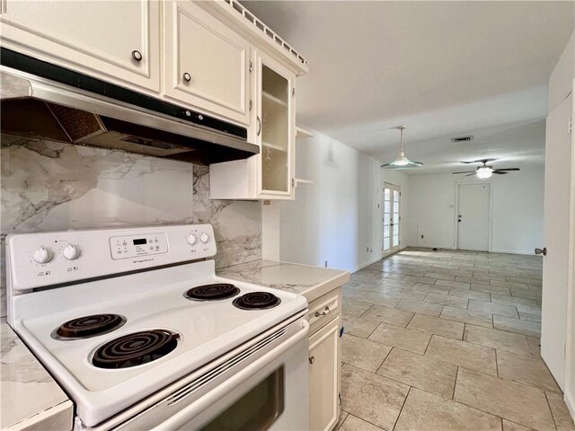 4505 Mount Vernon Dr, Corpus Christi, TX 78411 - kitchen with electric stove, under cabinet range hood, light countertops, a ceiling fan, and glass insert cabinets