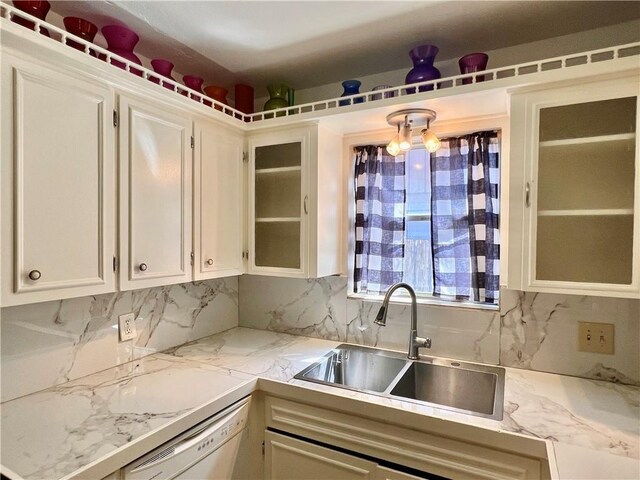 4505 Mount Vernon Dr, Corpus Christi, TX 78411 - kitchen with white dishwasher, white cabinets, light countertops, backsplash, and glass insert cabinets