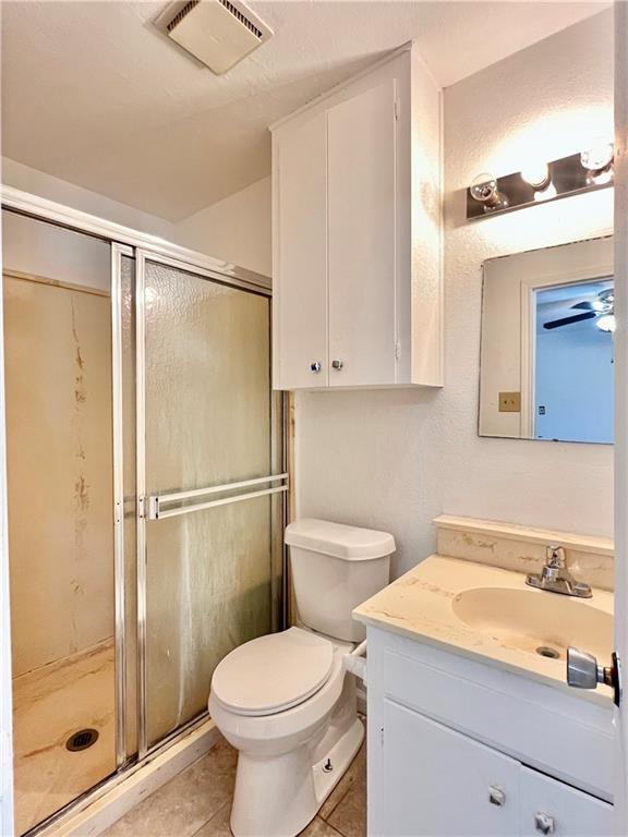 4505 Mount Vernon Dr, Corpus Christi, TX 78411 - bathroom with vanity, a shower stall, and tile patterned flooring