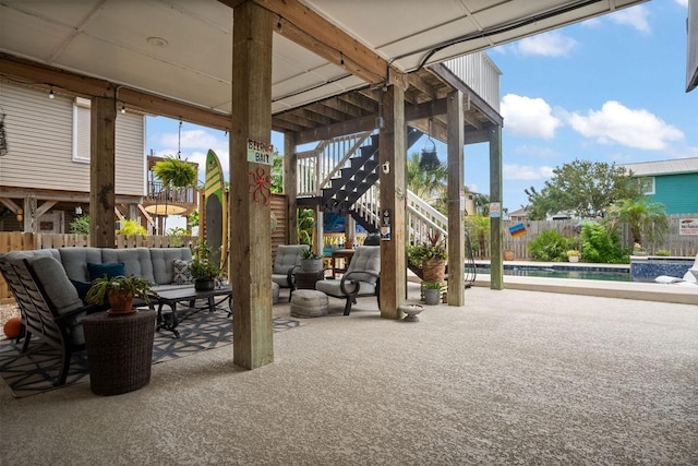 view of patio / terrace featuring a fenced in pool, fence, an outdoor hangout area, and stairs