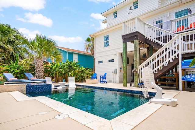 view of pool featuring stairs, a patio, a jacuzzi, and a fenced in pool