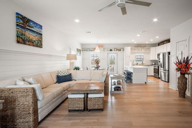 living area featuring recessed lighting, visible vents, and light wood finished floors