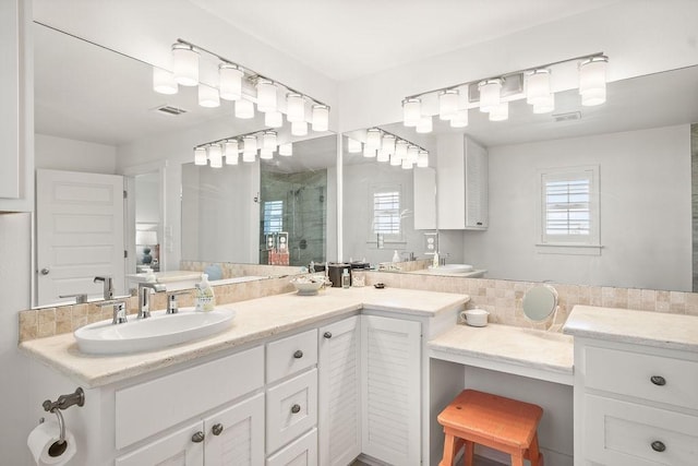 full bath featuring a wealth of natural light, a stall shower, a sink, and double vanity