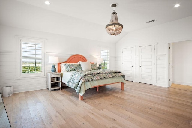 bedroom with visible vents, lofted ceiling, light wood-type flooring, a notable chandelier, and recessed lighting