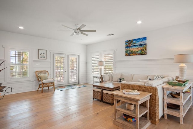 living room with recessed lighting, a healthy amount of sunlight, visible vents, and light wood finished floors