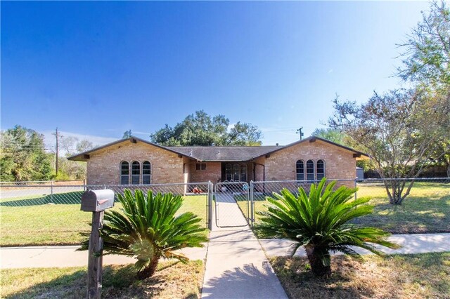 1414 Mockingbird Ln, Beeville, TX 78102 - view of front of house featuring brick siding and a gate