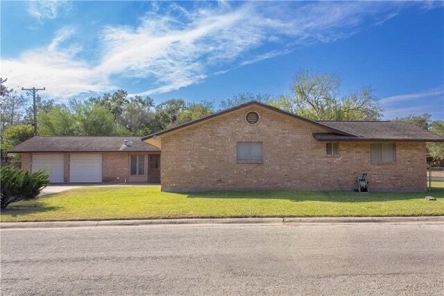 1414 Mockingbird Ln, Beeville, TX 78102 - single story home with brick siding, a front lawn, driveway, and an attached garage