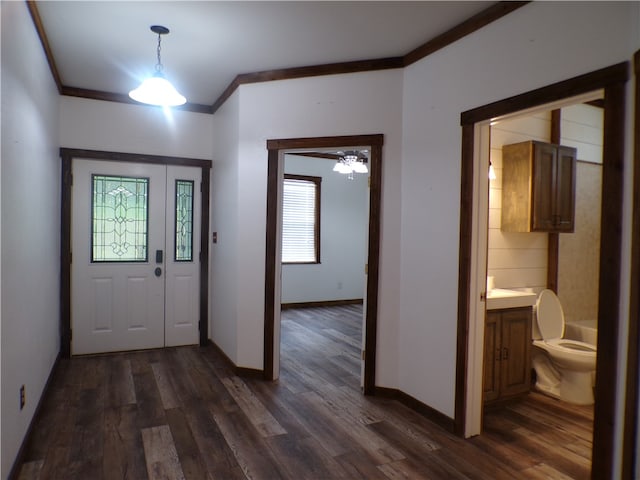 foyer entrance featuring ceiling fan, dark hardwood / wood-style floors, and crown molding