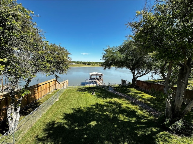 view of yard featuring a water view and a boat dock