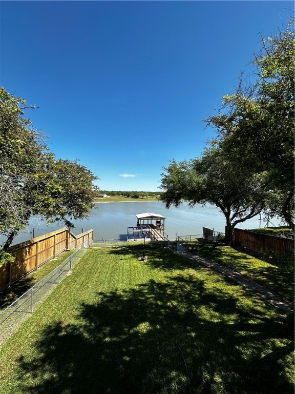 view of dock featuring a water view and a lawn