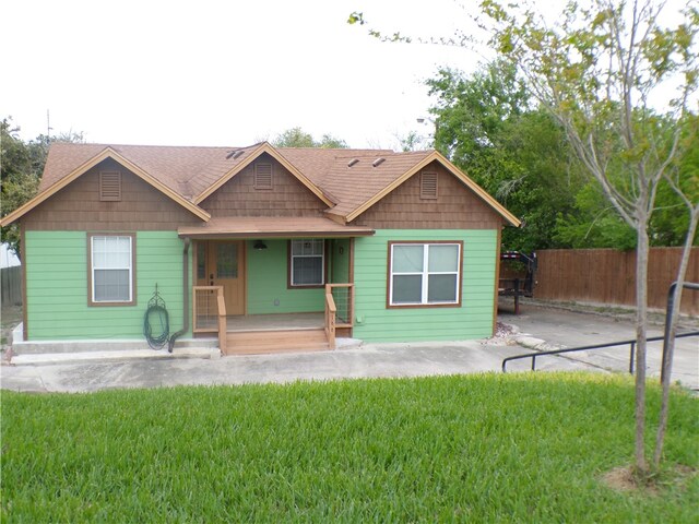 view of front of property with a porch and a front lawn