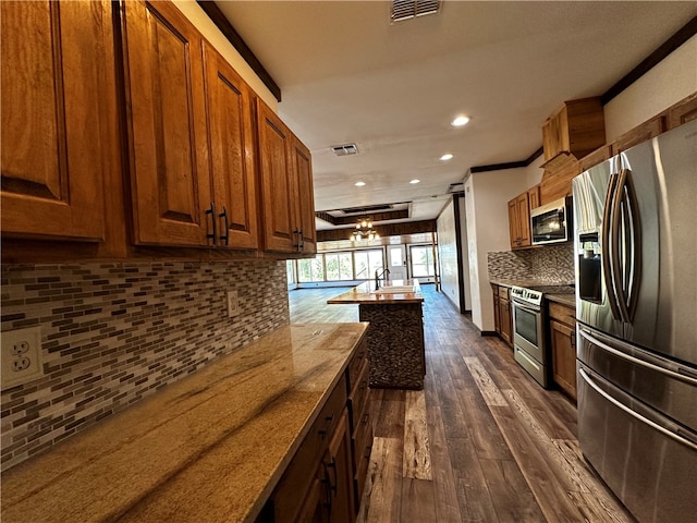 kitchen featuring appliances with stainless steel finishes, tasteful backsplash, a chandelier, crown molding, and dark hardwood / wood-style flooring