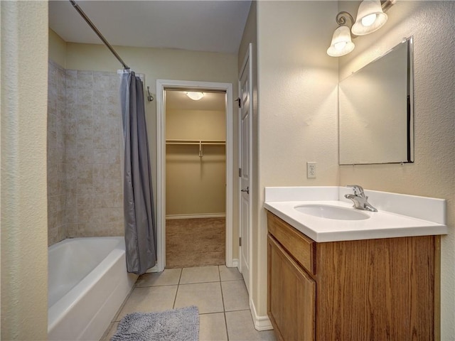 14422 Verdemar Dr, Corpus Christi, TX 78418 - full bath featuring tile patterned flooring, a spacious closet, baseboards, shower / bath combo with shower curtain, and vanity