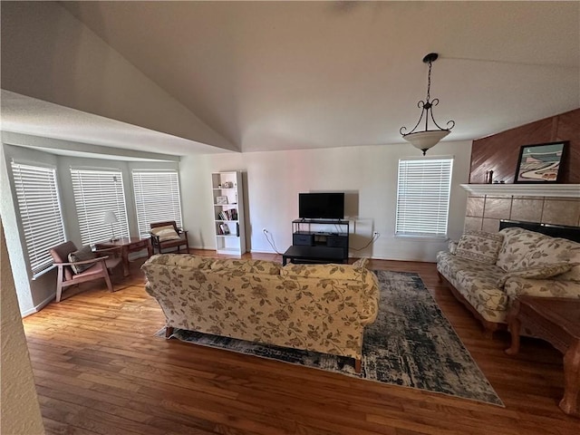 living area with lofted ceiling and wood finished floors