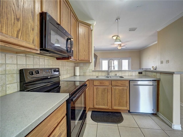 kitchen featuring a sink, visible vents, black appliances, and crown molding