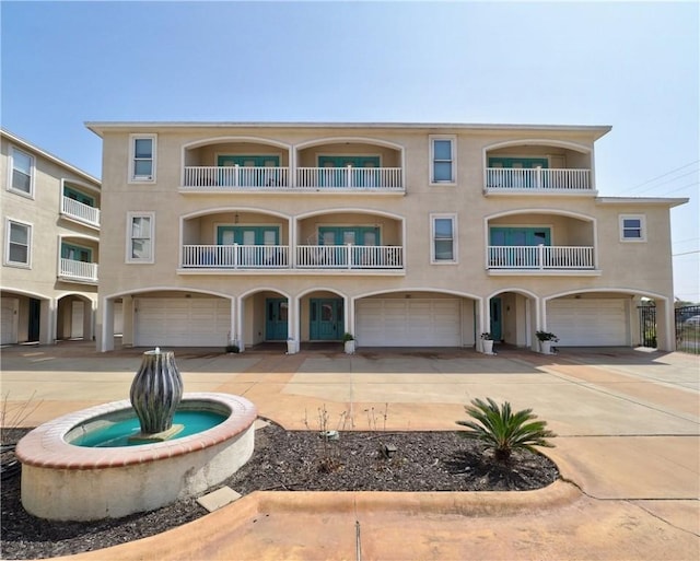 14422 Verdemar Dr, Corpus Christi, TX 78418 - view of front of property with a garage, concrete driveway, and stucco siding