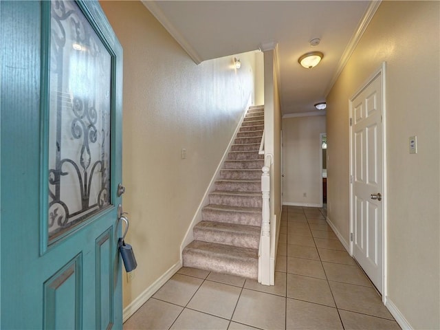 foyer with stairs, baseboards, ornamental molding, and light tile patterned flooring