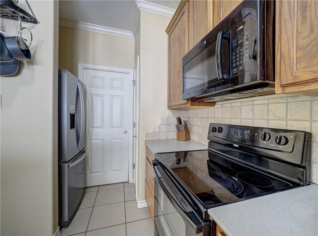 14422 Verdemar Dr, Corpus Christi, TX 78418 - kitchen with crown molding, light countertops, decorative backsplash, light tile patterned flooring, and black appliances