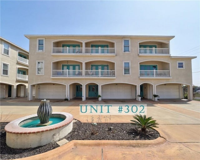 view of building exterior featuring driveway and a garage