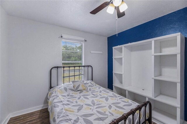 110 Wildwood, Rockport, TX 78382 - bedroom with a textured ceiling, wood finished floors, and ceiling fan