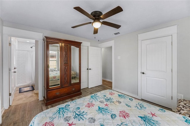 110 Wildwood, Rockport, TX 78382 - bedroom with wood finished floors, a ceiling fan, and connected bathroom