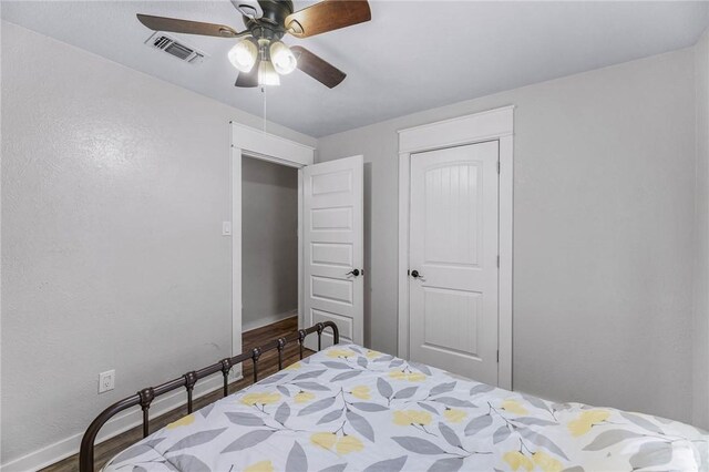 110 Wildwood, Rockport, TX 78382 - bedroom featuring wood finished floors, a ceiling fan, and a closet