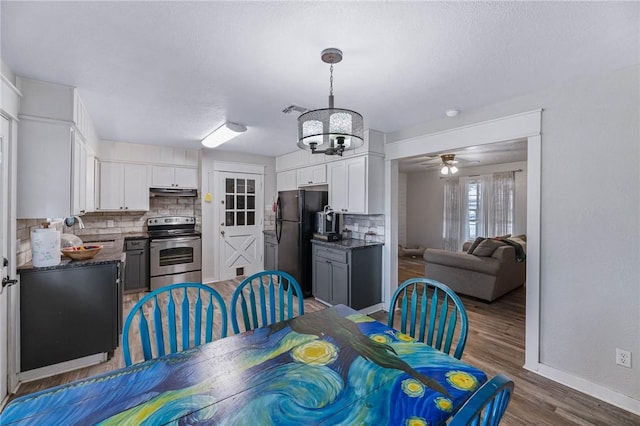 110 Wildwood, Rockport, TX 78382 - dining area featuring a chandelier, wood finished floors, and ceiling fan