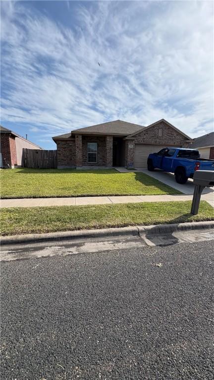 3013 Masterson Dr, Corpus Christi, TX 78415 - view of front of property featuring concrete driveway, a garage, and brick siding