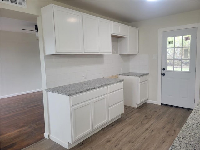 kitchen featuring white cabinetry and dark wood-type flooring