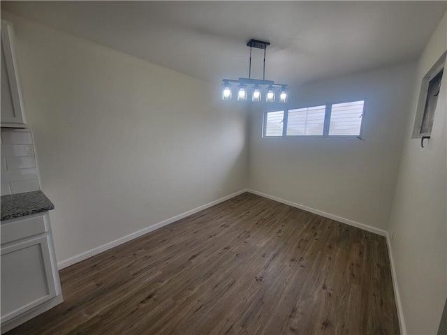 unfurnished dining area with dark hardwood / wood-style floors