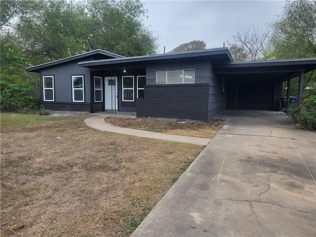 ranch-style house featuring a carport and a front yard