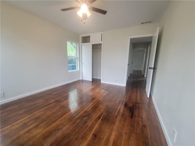 unfurnished bedroom featuring ceiling fan, a closet, and dark hardwood / wood-style floors