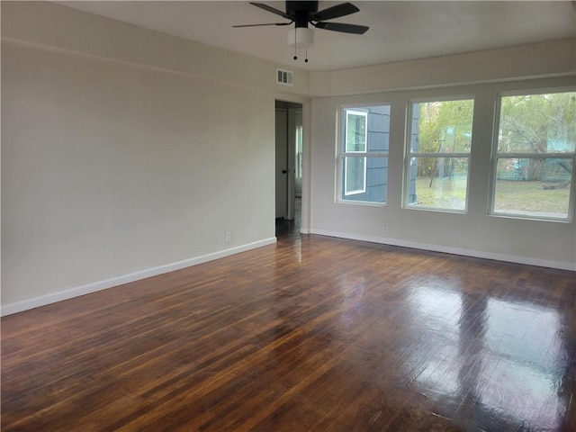 spare room featuring ceiling fan and dark wood-type flooring