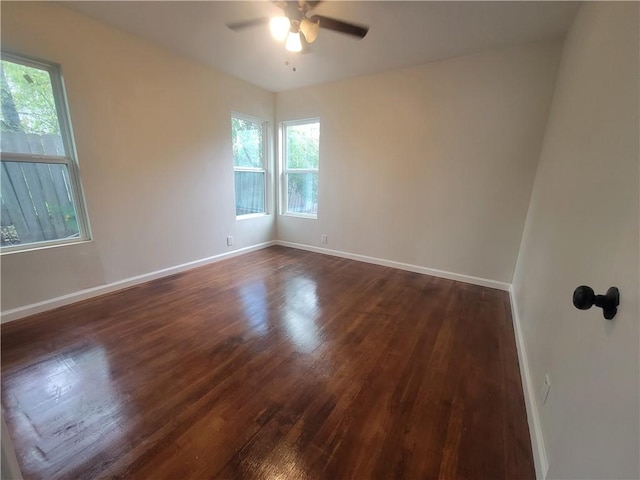 unfurnished room featuring ceiling fan and dark wood-type flooring