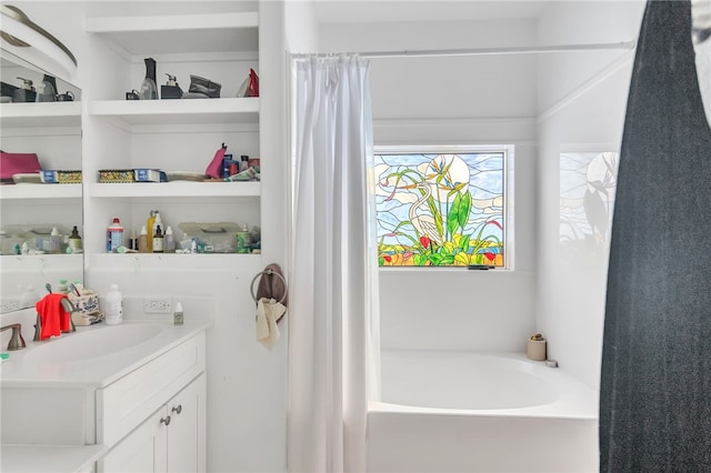 bathroom featuring vanity and a tub