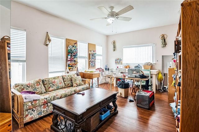 living room with ceiling fan and dark hardwood / wood-style floors