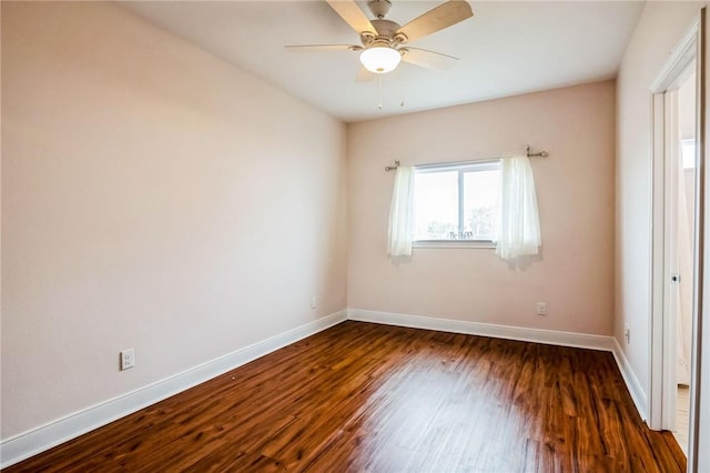 empty room with dark wood-type flooring and ceiling fan