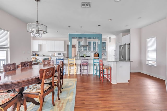 dining area with dark hardwood / wood-style flooring and a notable chandelier