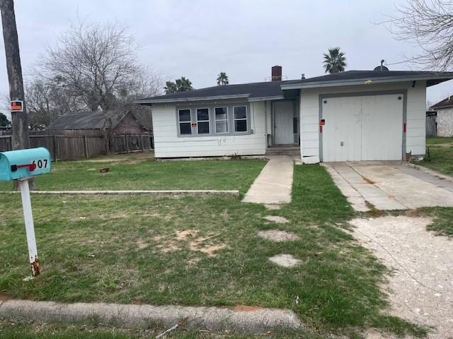 view of front of house with a garage and a front lawn