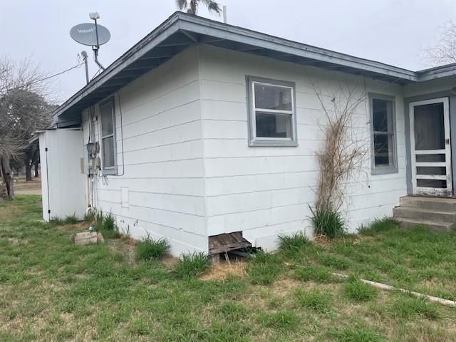 view of property exterior with a lawn