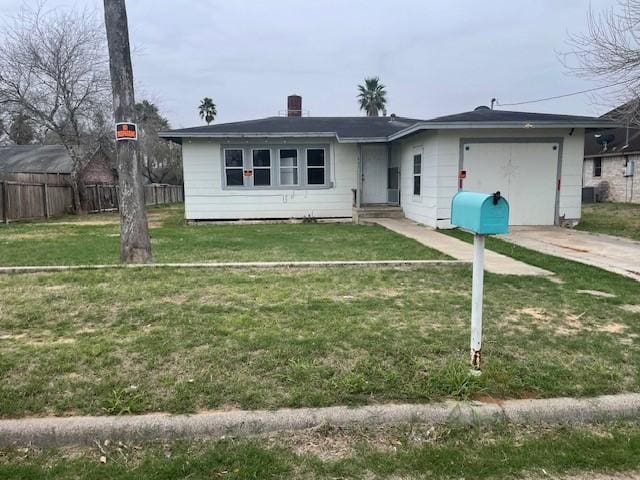 single story home featuring a garage and a front yard