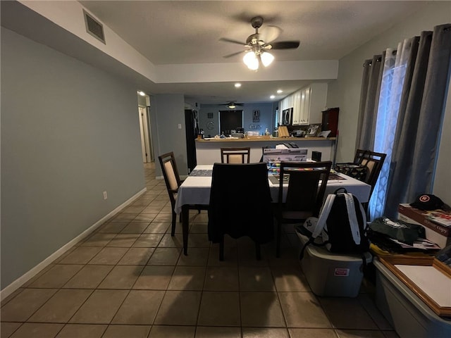 dining area with baseboards, visible vents, tile patterned flooring, and ceiling fan