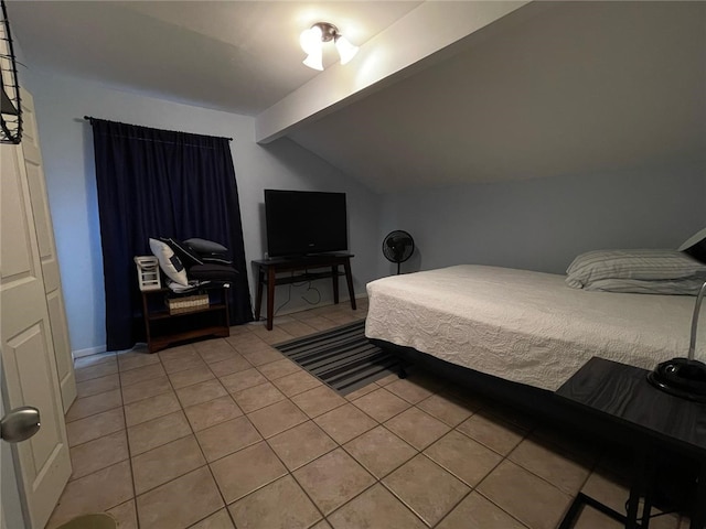 bedroom with lofted ceiling with beams and light tile patterned floors