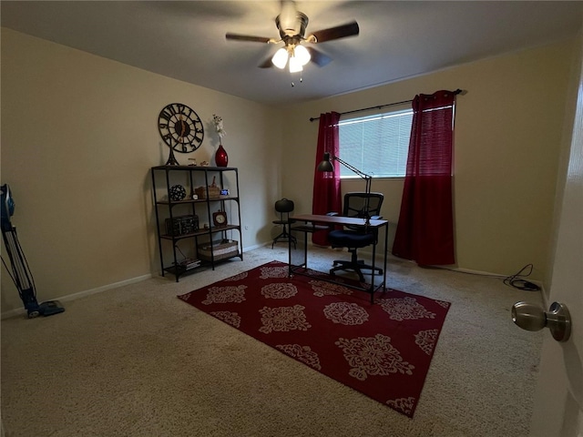 carpeted office space with baseboards and ceiling fan